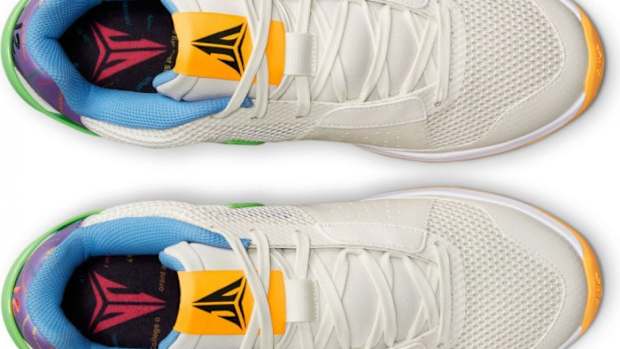 Detailed look at Ja Morant's white and yellow Nike shoes.